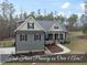 Charming two-story home featuring manicured landscaping and a welcoming front porch in a serene setting at 20 Crane Dr, Louisburg, NC 27549