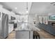Open kitchen with a large island, stainless steel appliances, and modern design at 20 Crane Dr, Louisburg, NC 27549