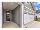 Exterior view of the house showcasing its vinyl siding, garage, front door, and concrete driveway at 204 Brickwell Way, Youngsville, NC 27596