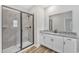Bathroom with a glass enclosed shower, granite countertop, and wood floor at 204 Jetson Creek Way, Youngsville, NC 27596