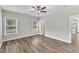 Bright bedroom featuring wood floors, a ceiling fan, and two windows at 204 Jetson Creek Way, Youngsville, NC 27596