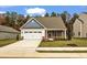 Charming single-Gathering home with a two-car garage, brick accents, and well-manicured lawn at 204 Jetson Creek Way, Youngsville, NC 27596