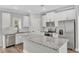 Modern kitchen featuring granite countertops, stainless steel appliances, and white cabinetry at 204 Jetson Creek Way, Youngsville, NC 27596