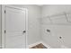 Functional laundry room with shelving, utility connections, and a door at 204 Jetson Creek Way, Youngsville, NC 27596
