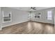 Spacious living room with hardwood floors, multiple windows, and a ceiling fan at 204 Jetson Creek Way, Youngsville, NC 27596