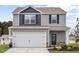 Charming two-story home featuring a two-car garage, stone accents, and classic curb appeal at 204 Shelfit Trl, Oxford, NC 27565