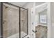 Bathroom features a glass shower with tile surround and modern fixtures at 208 Brickwell Way, Youngsville, NC 27596