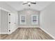 Light-filled bedroom boasts vaulted ceiling, neutral walls, and light wood flooring at 208 Brickwell Way, Youngsville, NC 27596