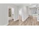 Bright hallway features wood-look floors, doorways to the bathroom, bedroom, and sliding glass door at 208 Brickwell Way, Youngsville, NC 27596