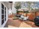 Charming brick patio with outdoor seating, fire pit, and lush landscaping for relaxing and entertaining at 2147 Wake Dr, Raleigh, NC 27608