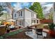 Outdoor space featuring a patio with comfortable seating, mature trees, and landscaping at 2147 Wake Dr, Raleigh, NC 27608