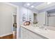 Classic bathroom featuring a quartz countertop, white vanity and fixtures, and ample lighting at 2147 Wake Dr, Raleigh, NC 27608