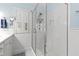 Bright, clean bathroom featuring a glass enclosed shower, white cabinets, and a window at 2147 Wake Dr, Raleigh, NC 27608