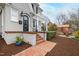 Charming front porch features brick steps, covered area, and beautiful landscaping, enhancing the home's curb appeal at 2147 Wake Dr, Raleigh, NC 27608