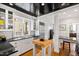 Bright kitchen featuring black countertops, white cabinetry, stainless steel appliances, and an island with a butcher block top at 2147 Wake Dr, Raleigh, NC 27608