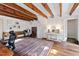 Bright living room with exposed beams, wood floors, and an eye-catching oriental rug at 2147 Wake Dr, Raleigh, NC 27608