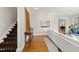 Bright living room with hardwood floors, neutral paint, and a staircase, offering a comfortable and inviting space at 2147 Wake Dr, Raleigh, NC 27608