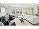 Bright and airy living room with a fireplace, large windows, and comfortable seating, perfect for relaxation at 2147 Wake Dr, Raleigh, NC 27608