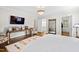 Bedroom featuring hardwood floors, stylish decor, a sitting area, and views into the ensuite bathroom at 2147 Wake Dr, Raleigh, NC 27608
