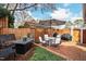 Cozy brick patio features an outdoor dining set, lounge seating, and privacy fence at 2147 Wake Dr, Raleigh, NC 27608