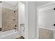 Neutral bathroom showcasing a shower-tub combo with decorative tile surround and a vanity with granite countertop at 305 Brickwell Way, Youngsville, NC 27596