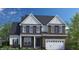 Beautiful two-story home featuring brick facade, white accents, and a two-car garage at 3184 Armeria Dr, Apex, NC 27502