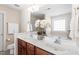 Bathroom with dual sinks, wood cabinets, and a garden tub under a bright window at 4511 All Points View Way, Raleigh, NC 27614