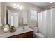 Neutral bathroom featuring a wide mirror, vanity with storage, and shower/tub with curtain at 4511 All Points View Way, Raleigh, NC 27614