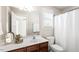 Bathroom featuring a wood vanity, large mirror, and shower with curtain at 4511 All Points View Way, Raleigh, NC 27614