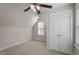 Carpeted bedroom with ceiling fan, dormer windows and closet with bifold doors at 4511 All Points View Way, Raleigh, NC 27614