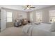 Inviting bedroom featuring carpet flooring, a ceiling fan and a sitting area with cozy armchairs at 4511 All Points View Way, Raleigh, NC 27614
