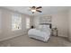 Bright bedroom showcasing large windows, carpet flooring, and a ceiling fan at 4511 All Points View Way, Raleigh, NC 27614