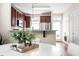 Cozy dining area with modern cabinets, stainless steel appliances, and view of the table setting at 4511 All Points View Way, Raleigh, NC 27614