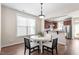 Bright dining area featuring a round table and chairs adjacent to a modern kitchen at 4511 All Points View Way, Raleigh, NC 27614
