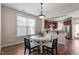 Inviting dining area showcases a white table, hardwood floors, and access to the kitchen and outdoor area at 4511 All Points View Way, Raleigh, NC 27614