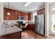 Well-equipped kitchen features stainless steel appliances, granite counters, and dark wood cabinetry at 4511 All Points View Way, Raleigh, NC 27614