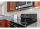 Kitchen showcasing granite countertops, dark wood cabinets, and stainless steel appliances at 4511 All Points View Way, Raleigh, NC 27614