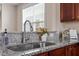 Close-up of kitchen sink with granite countertops and stainless steel faucet at 4511 All Points View Way, Raleigh, NC 27614