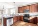 Updated kitchen features wood cabinets, granite countertops, and stainless steel appliances at 4511 All Points View Way, Raleigh, NC 27614