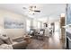 Open-concept living room featuring hardwood floors, comfortable seating, and seamless access to the dining area at 4511 All Points View Way, Raleigh, NC 27614
