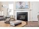 Close-up of a fireplace, hardwood floors, and stylish coffee table with decorative accents at 4511 All Points View Way, Raleigh, NC 27614