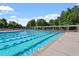 A view of the community pool with lap lanes, lounge chairs, and clear blue water at 4511 All Points View Way, Raleigh, NC 27614