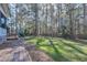 Spacious backyard with mature trees, lush lawn, and a playground set, perfect for Gathering fun and outdoor adventures at 5105 Watkinsdale Ave, Raleigh, NC 27613