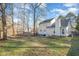 Expansive backyard with a deck, mature trees, and a partial fence line at 5302 Silkwood Dr, Durham, NC 27713