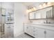 Bathroom featuring double sink vanity, framed mirror, updated fixtures and tub with shower at 5302 Silkwood Dr, Durham, NC 27713