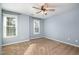 Light blue bedroom with ceiling fan and two windows, offering plenty of natural light at 5302 Silkwood Dr, Durham, NC 27713