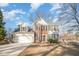 Charming two-story home with a manicured lawn, attached garage, and traditional architectural details at 5302 Silkwood Dr, Durham, NC 27713