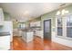 Bright kitchen with white cabinets, granite countertops, and an island, open to the dining at 5302 Silkwood Dr, Durham, NC 27713