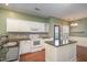 Well-lit kitchen with stainless appliances, granite countertops, and island with sink at 5302 Silkwood Dr, Durham, NC 27713