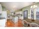 Bright kitchen with white cabinets, island, stainless steel appliances, and hardwood floors at 5302 Silkwood Dr, Durham, NC 27713